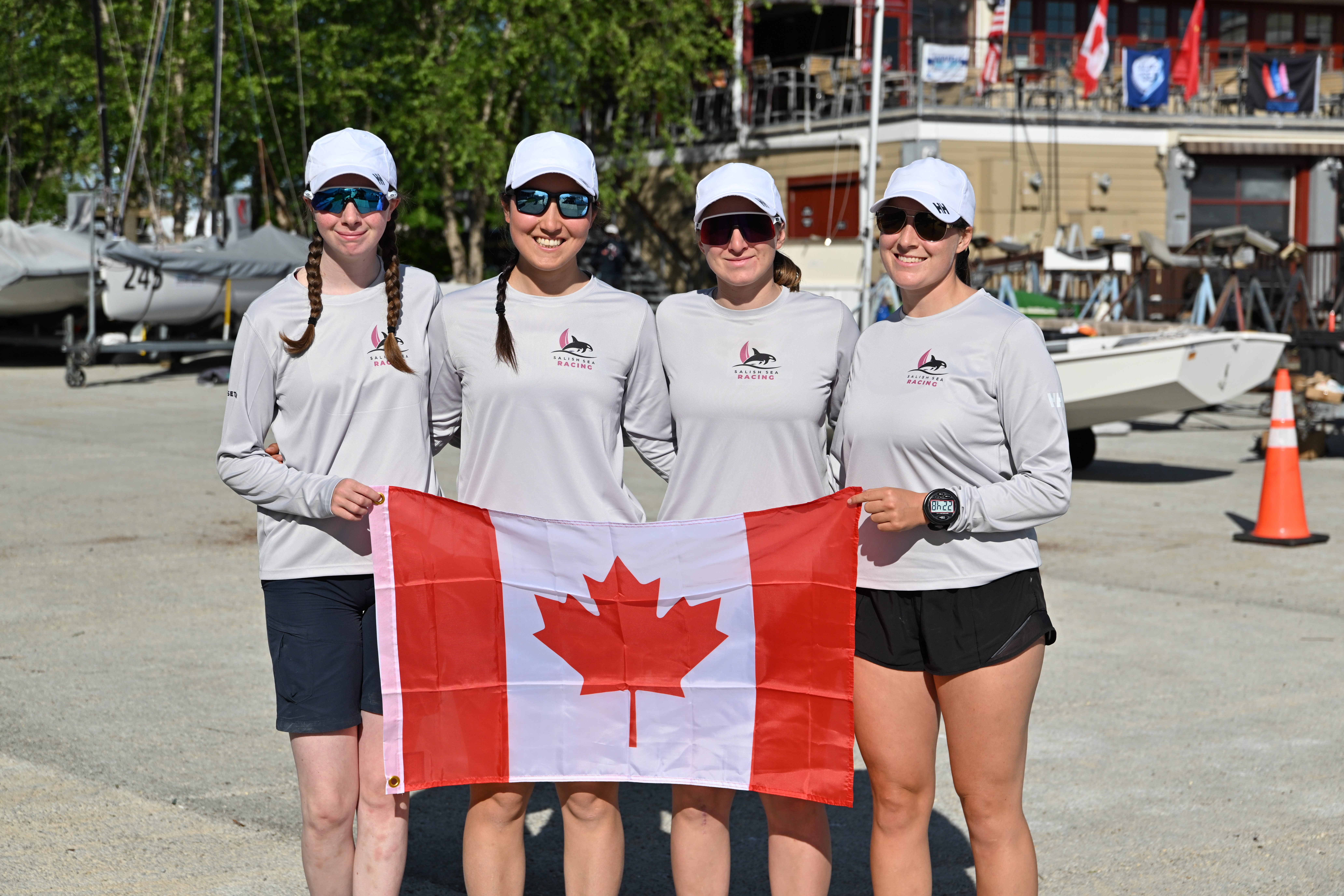 Team Canada posing with the Canadian flag