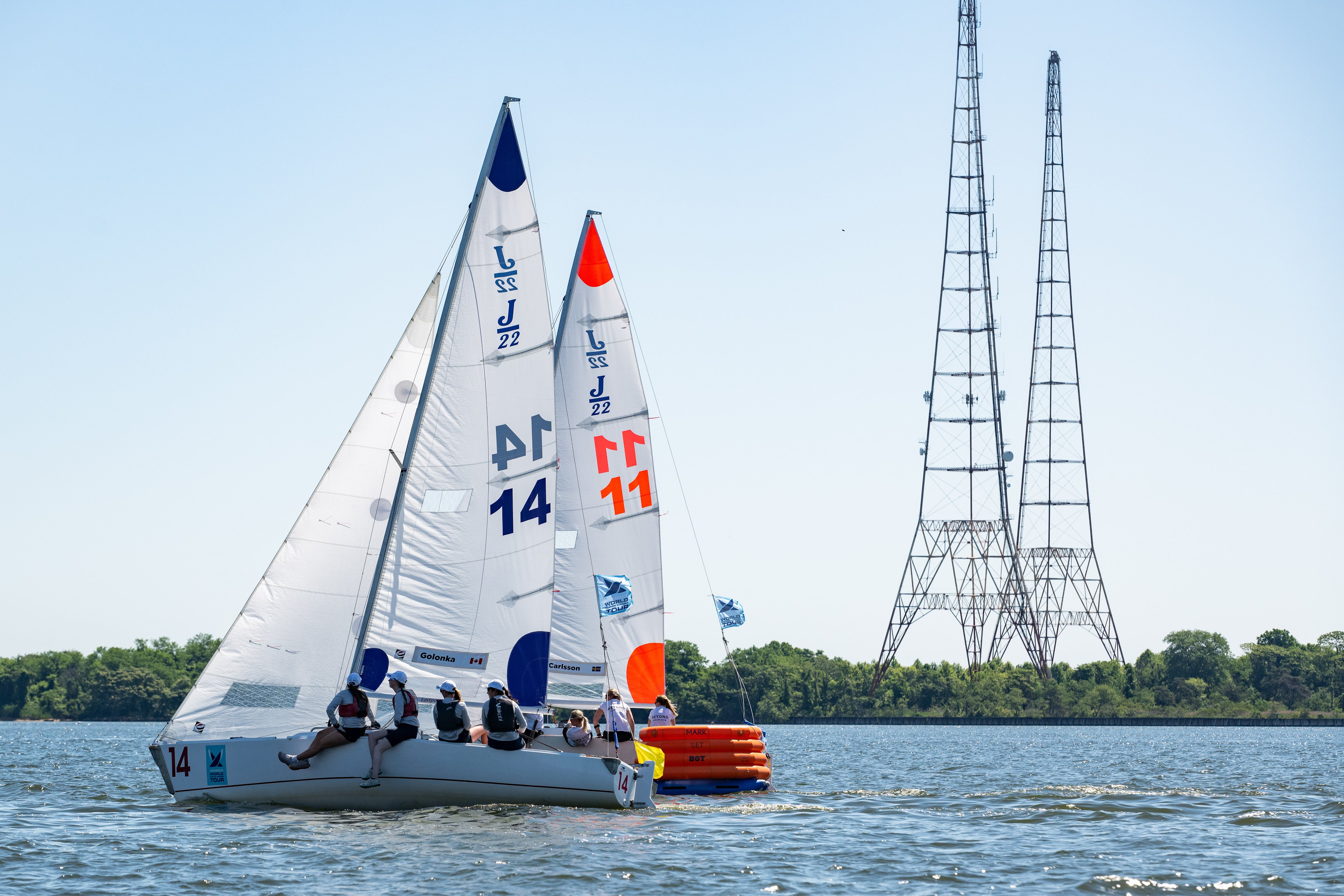 Fleet racing under colorful spinnakers with the Annapolis skyline behind